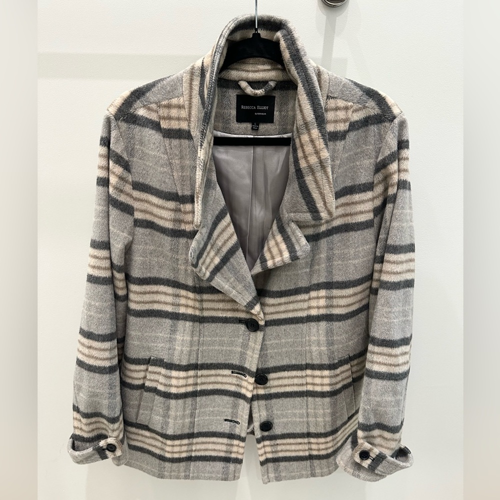 Grey, cream and tan plaid lined peacoat.  Tab button on sleeve.  Acrylic & wool